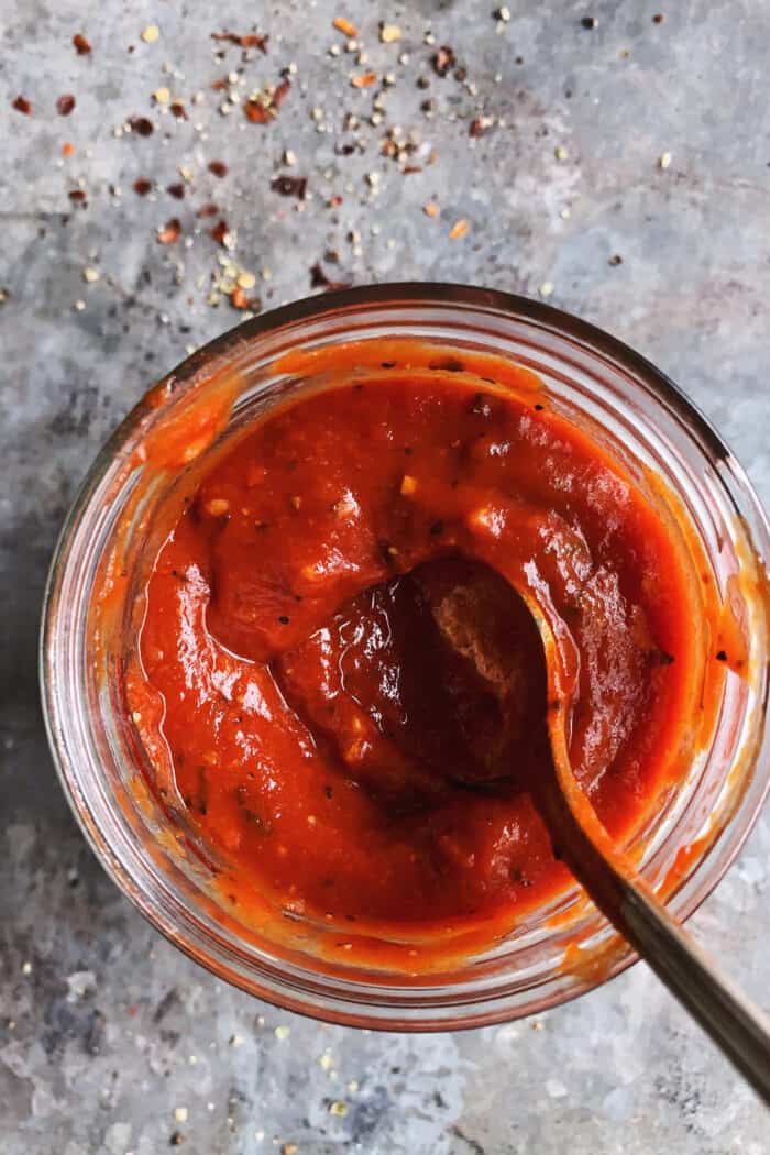 homemade sauce for pizza, in a jar with a spoon
