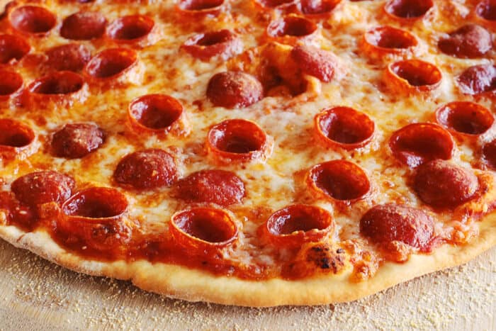 close-up of thin crust pizza with pepperoni and cheese