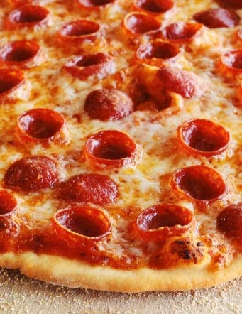 thin crust pizza dough crust on a pepperoni pizza