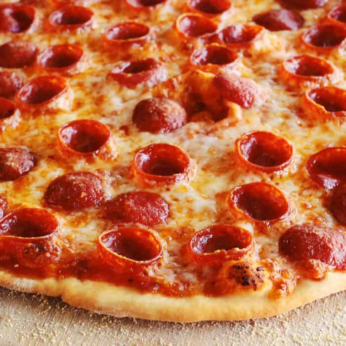 thin crust pizza dough crust on a pepperoni pizza