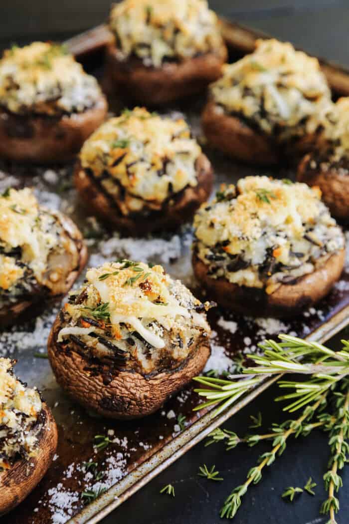 a pan of baked mushroom caps stuffed with mashed potatoes and wild rice