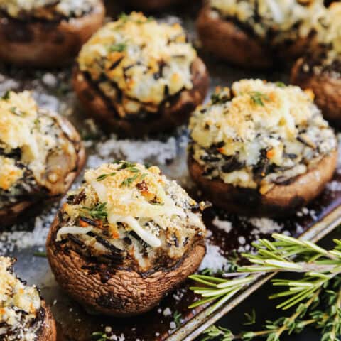baked potato and wild rice stuffed mushrooms on a rimmed sheet pan