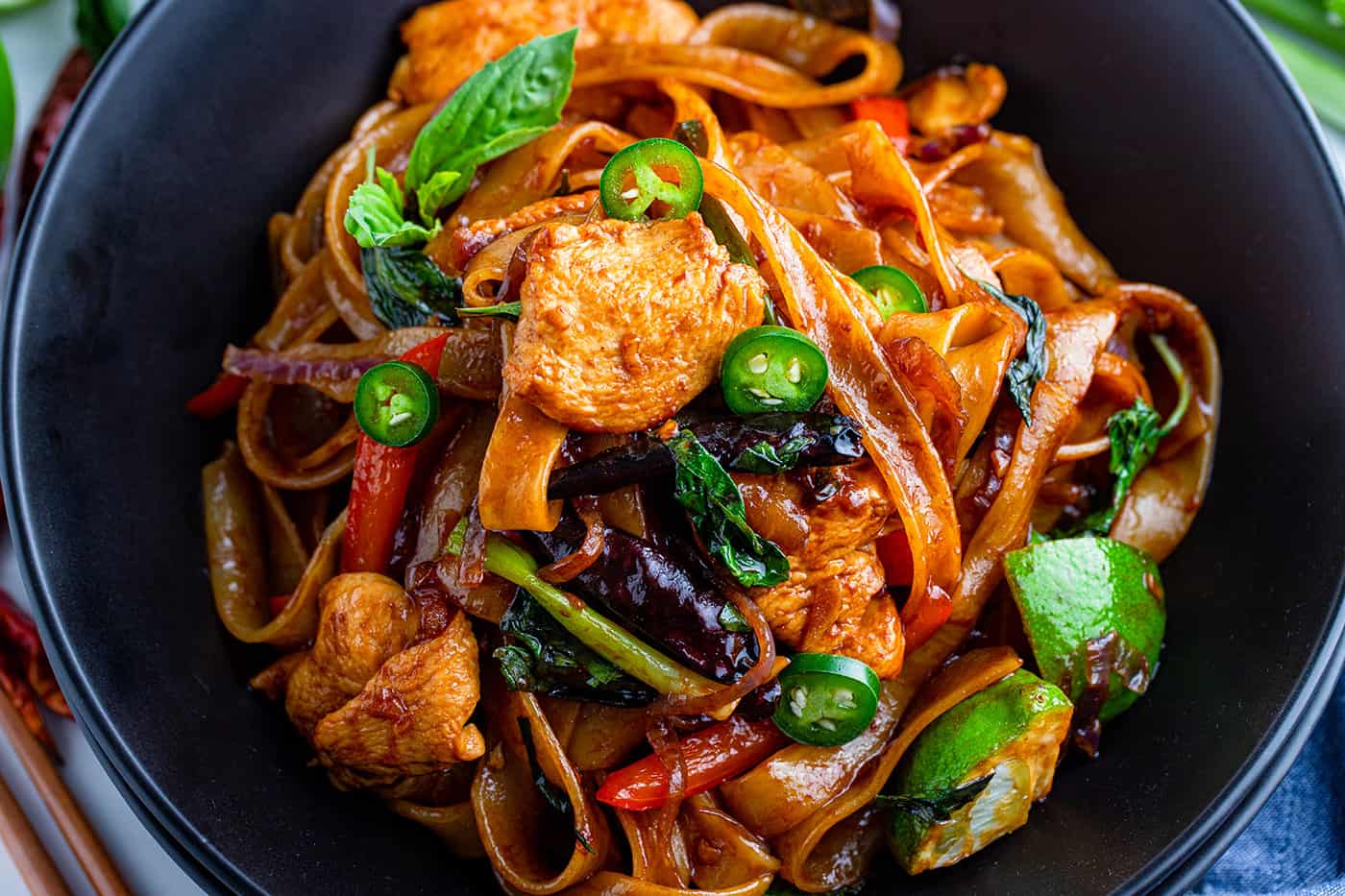 drunken noodles in a black bowl