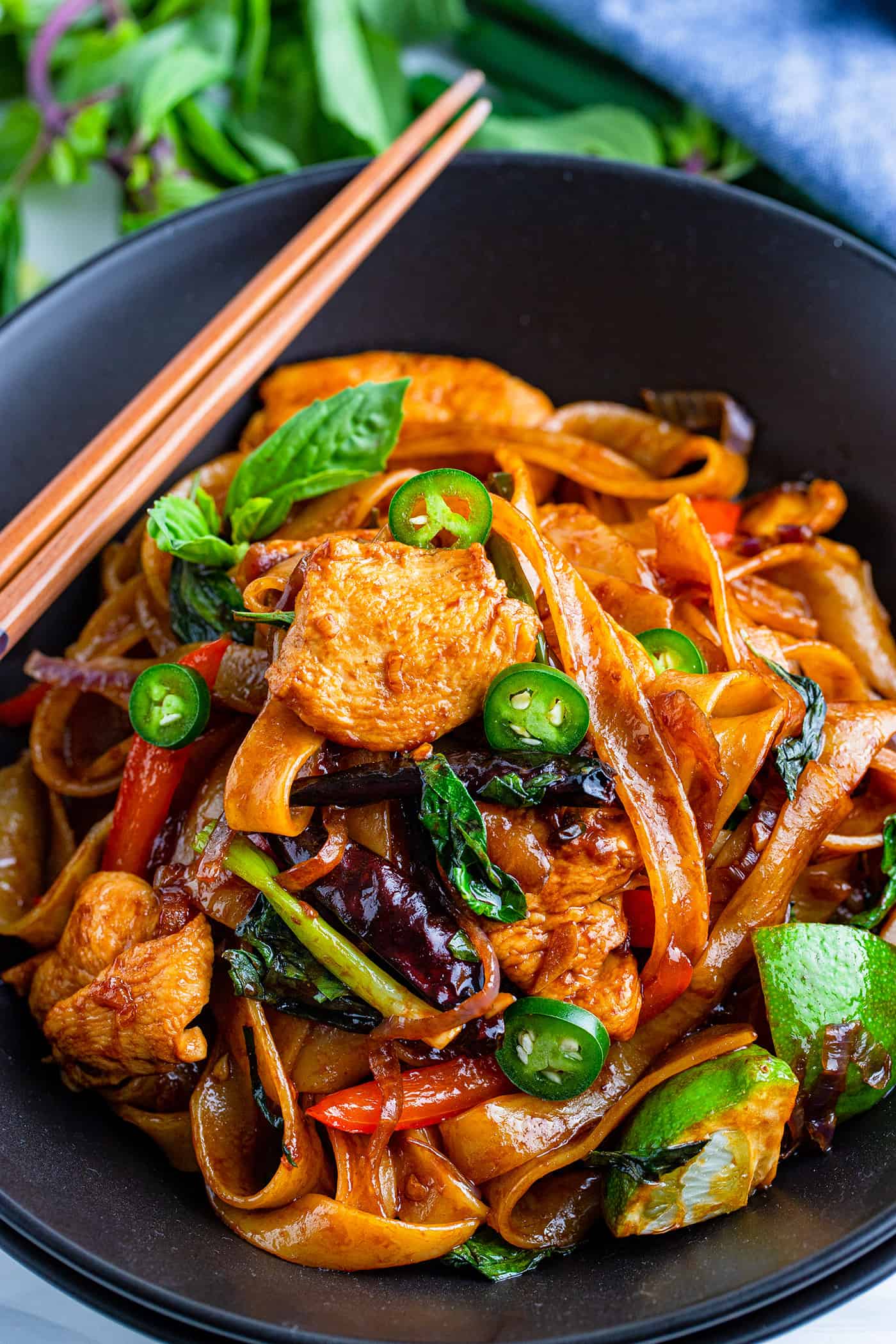 Thai rice noodle dish in a black bowl