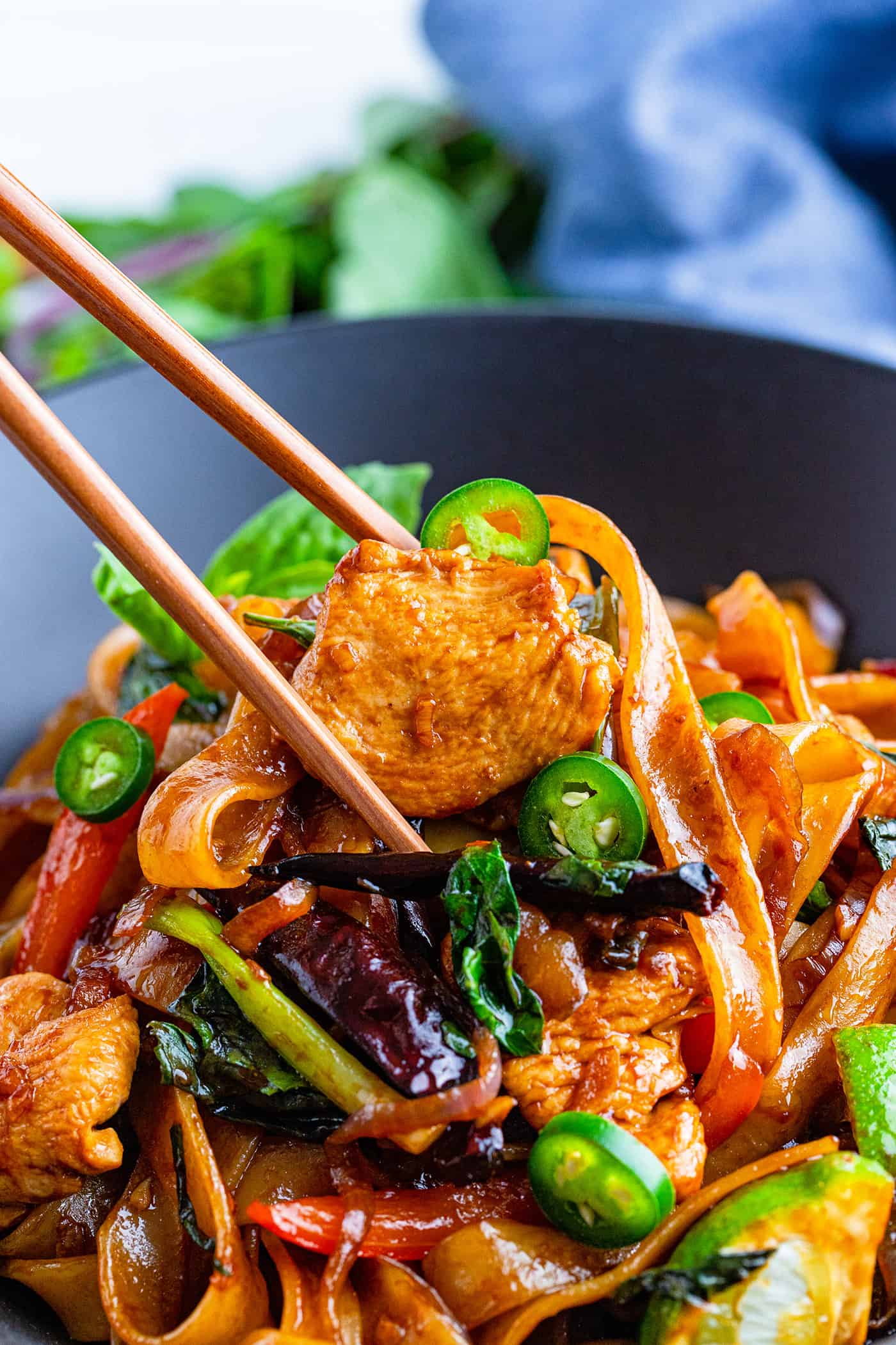 chop sticks in a bowl of Thai drunken noodles