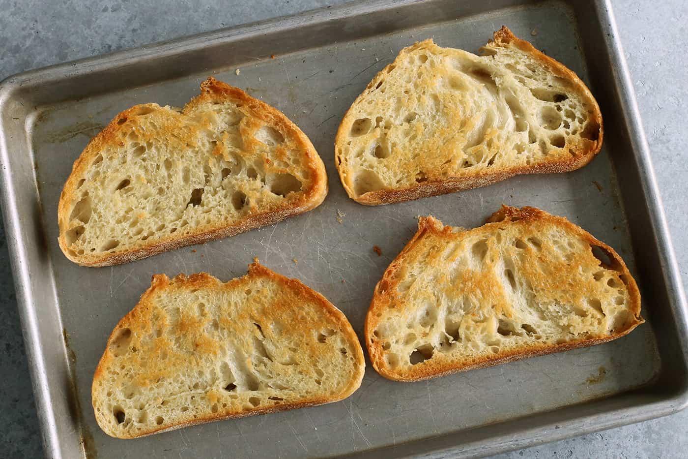 sliced of toasted bread on a sheet pan