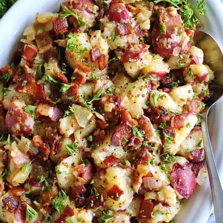 German potato salad with bacon on a white platter