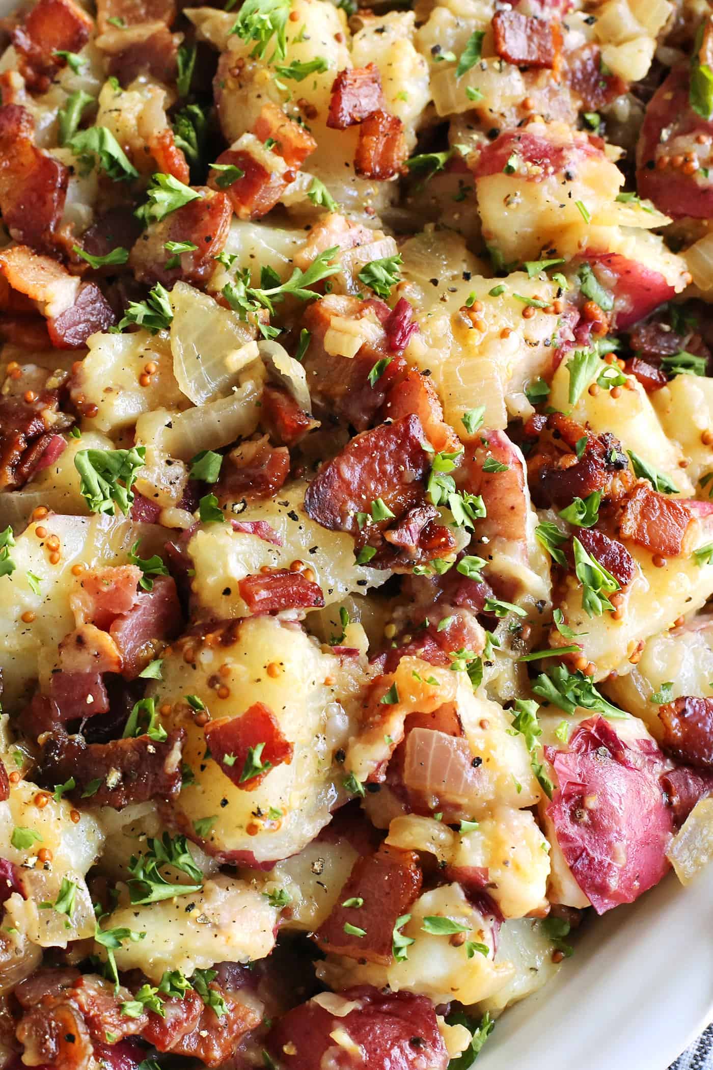 close-up photo of German potato salad that shows the bacon pieces and whole grain mustard