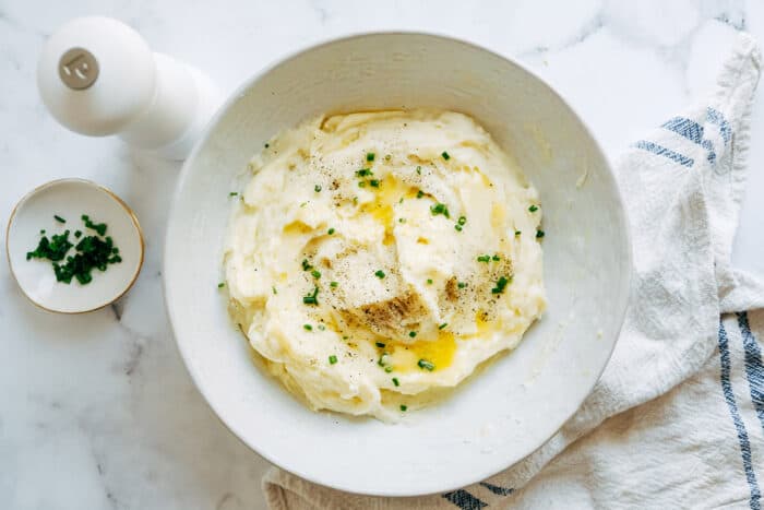 potatoes mashed in a low wide bowl, with melty butter and chives