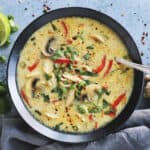 coconut curry chicken soup in a black bowl