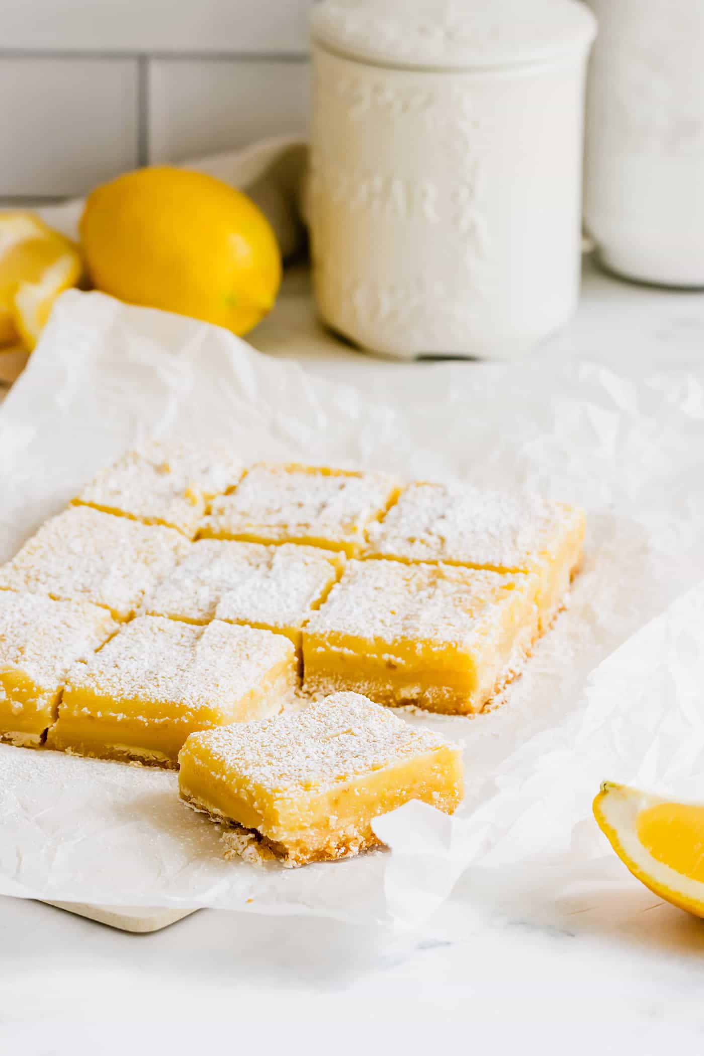 bars consisting of a shortbread crust topped with lemon curd and sprinkled with powdered sugar