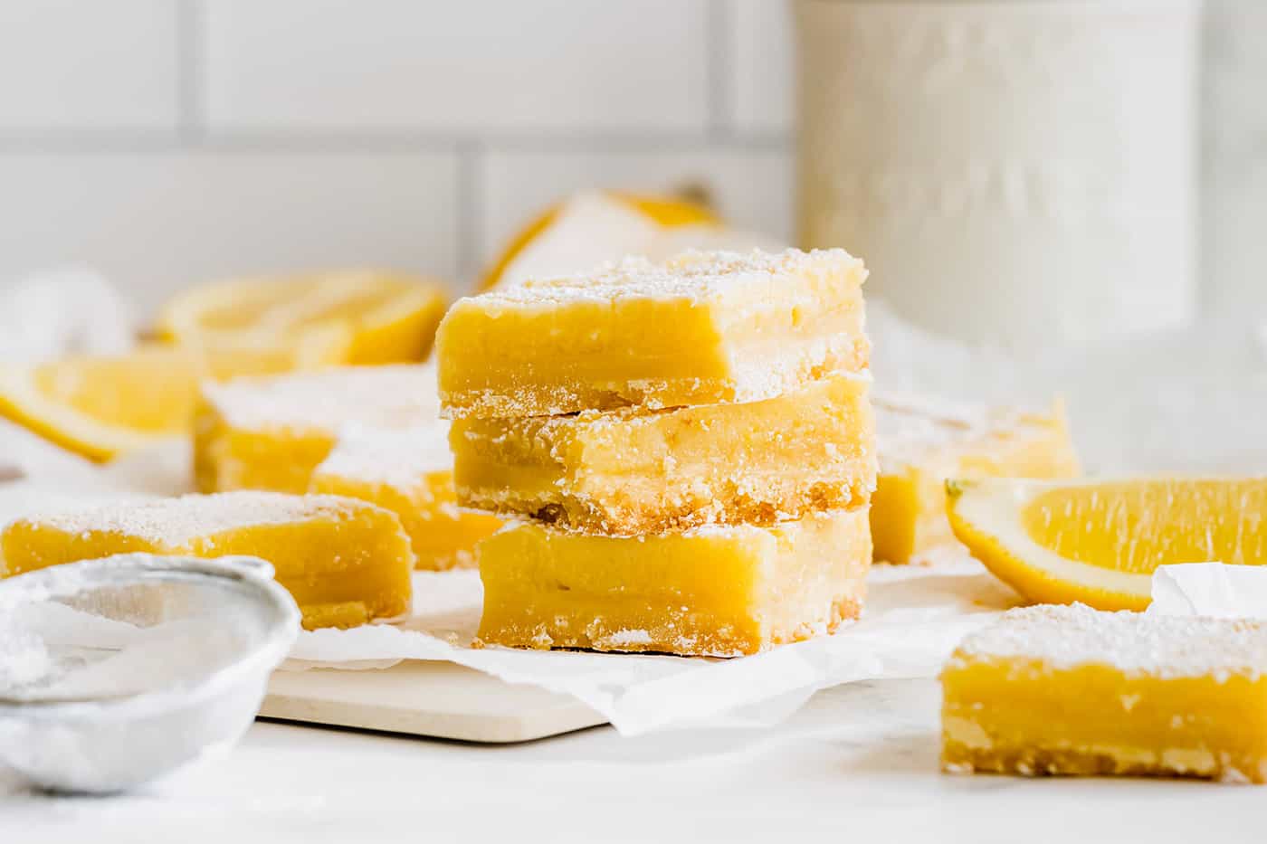 a stack of lemon bars surrounded by more lemon bars