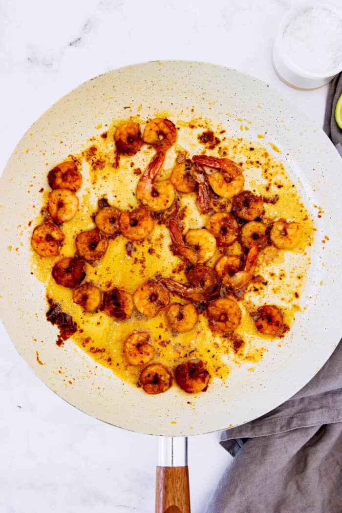 shrimp sautéed in a white fry pan