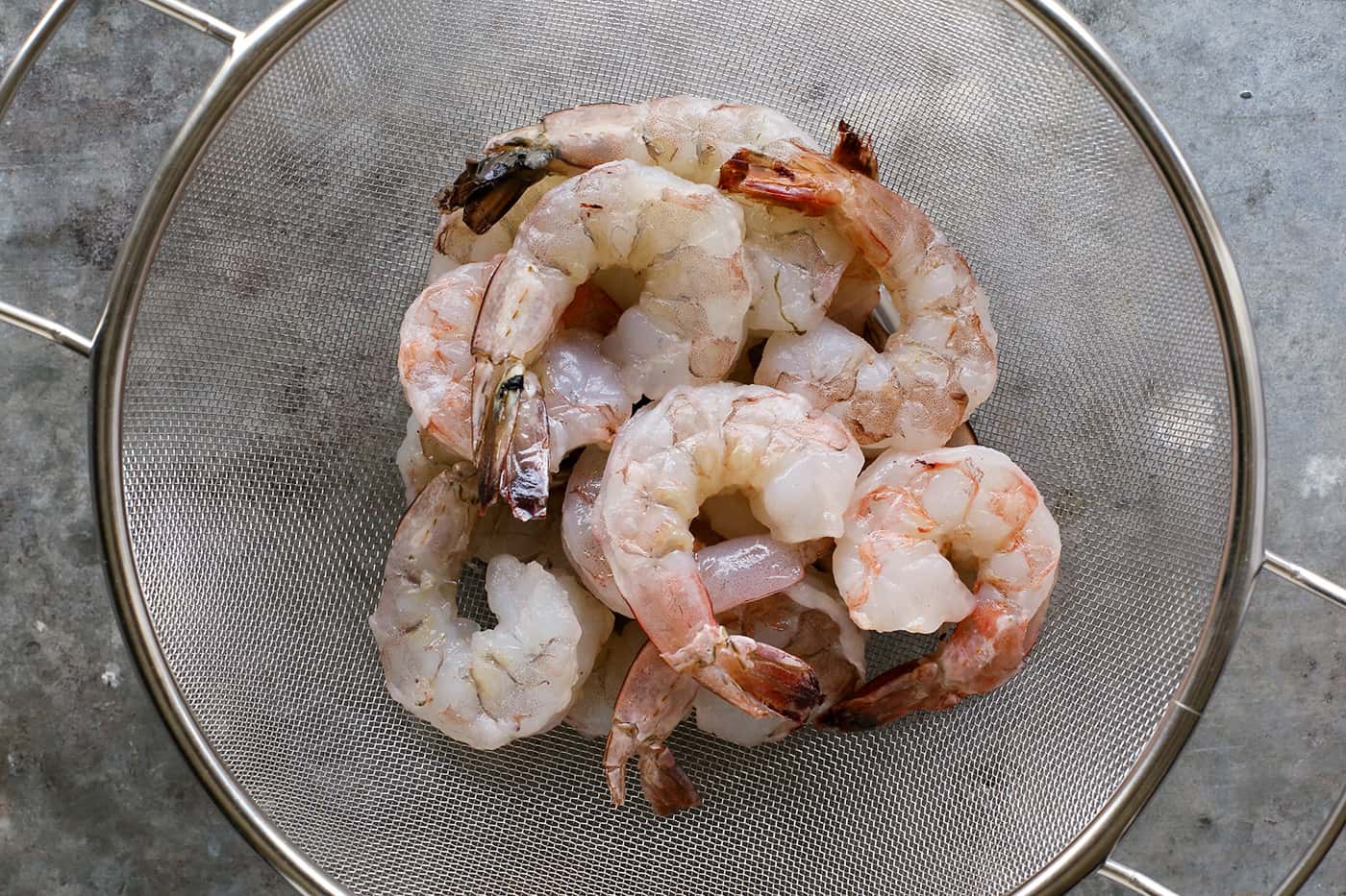 raw shrimp in a colander