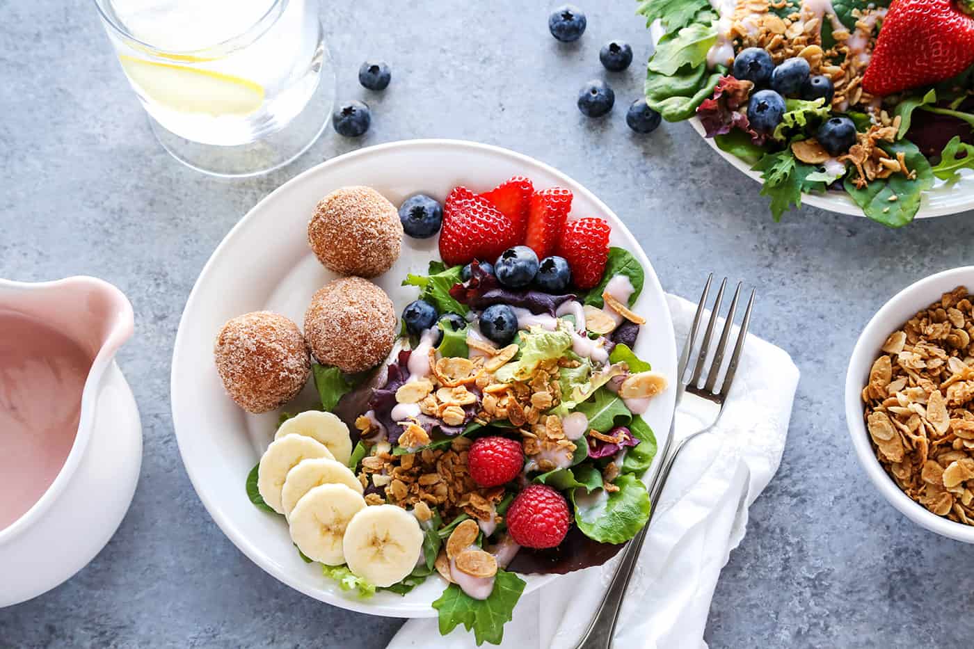 Overhead view of a plate of Breakfast Salad served with a few donut holes