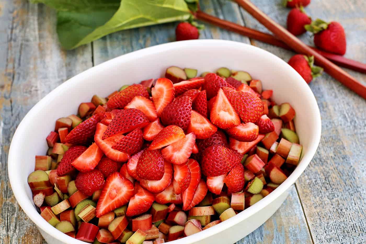 Chopped strawberries and rhubarb in an oval baking dish