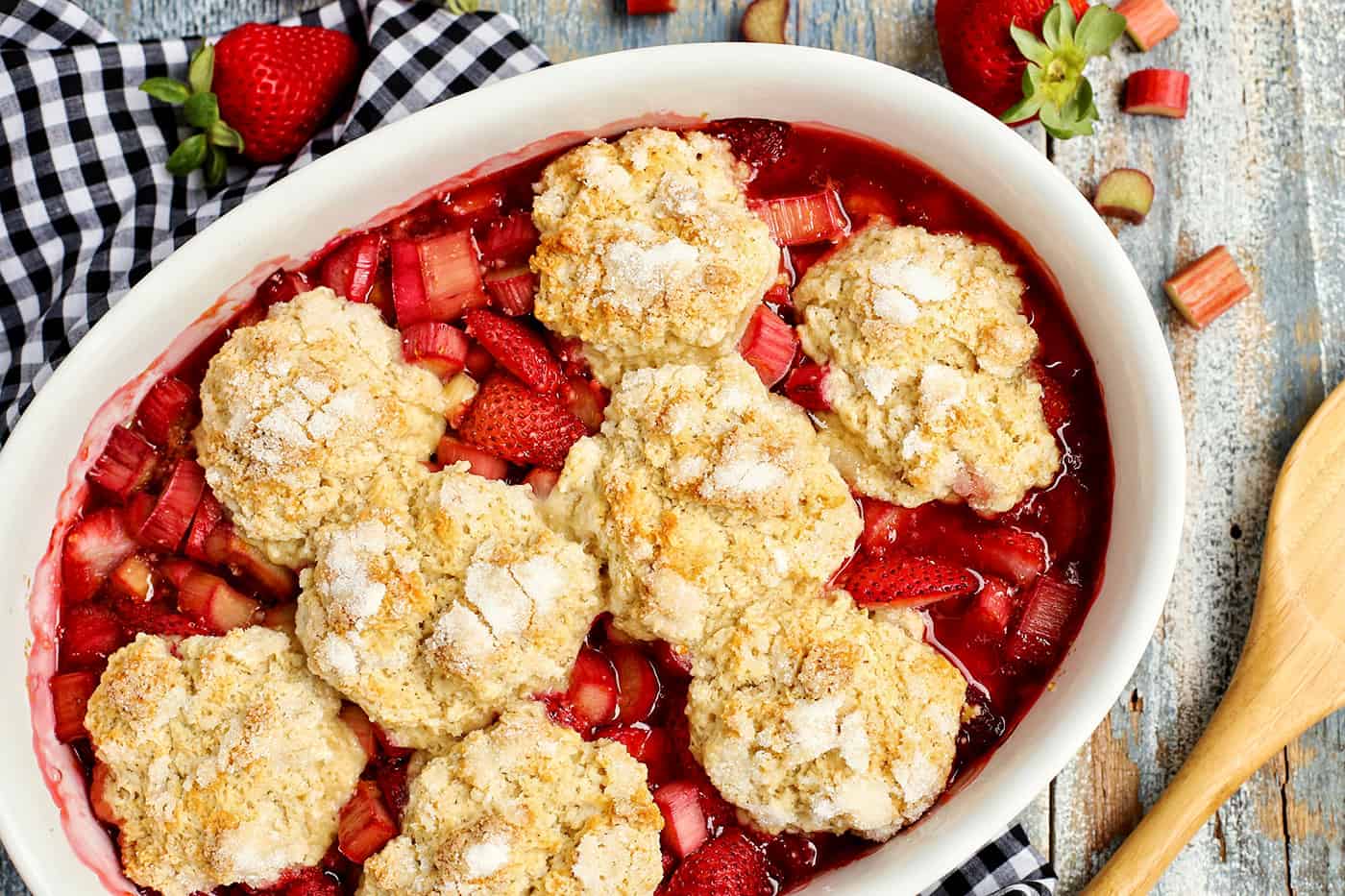 Overhead view of an oval baking dish of Strawberry Rhubarb cobbler