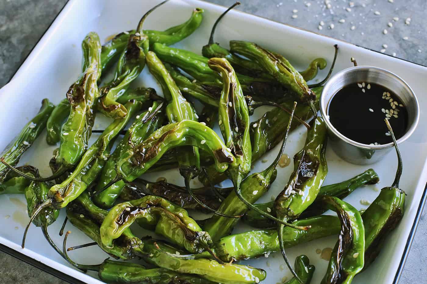 blistered peppers and a cup of soy honey sauce for dipping