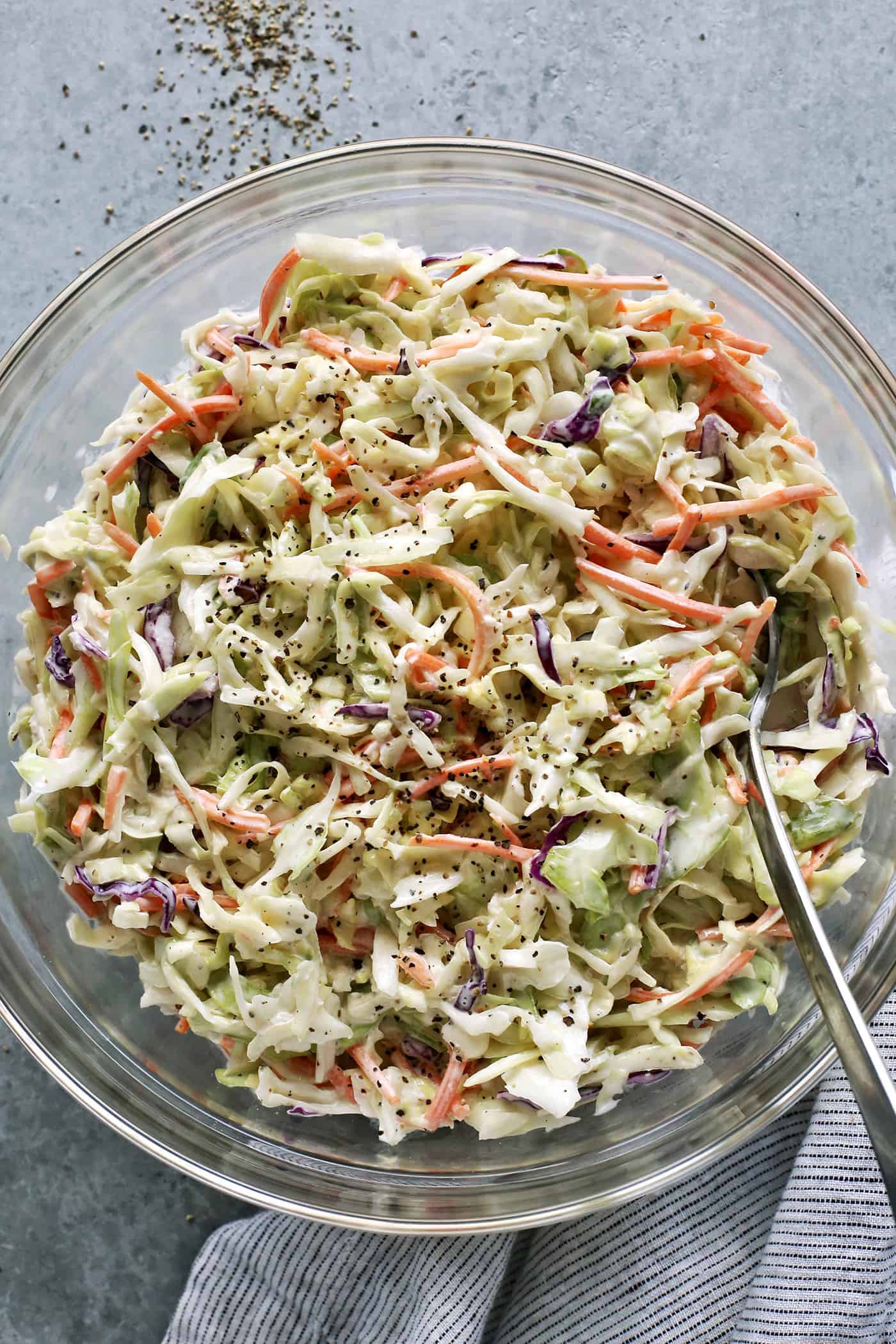 overhead view of creamy coleslaw in a large clear bowl