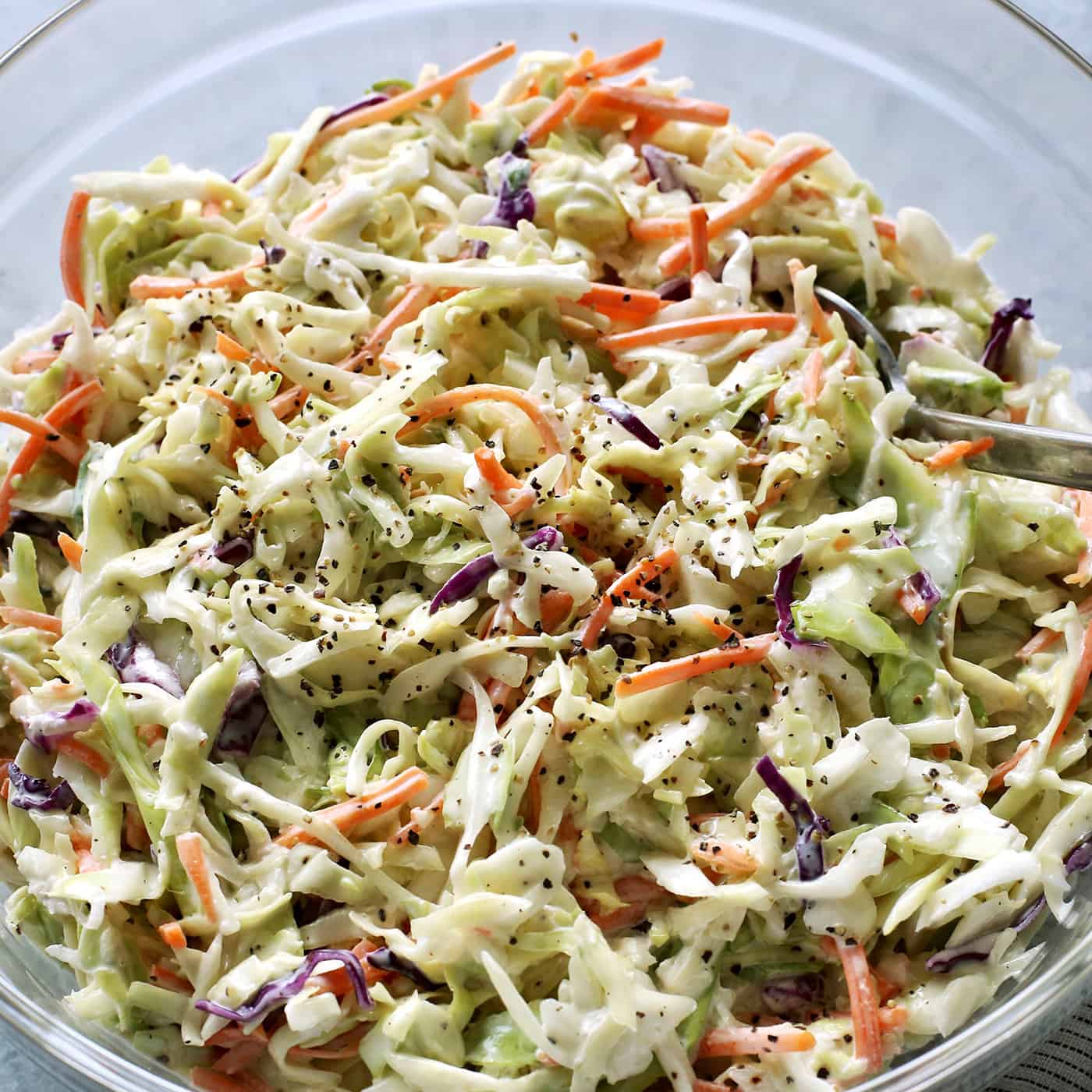 salad of shredded cabbage and carrots with a mayo and sour cream based dressing