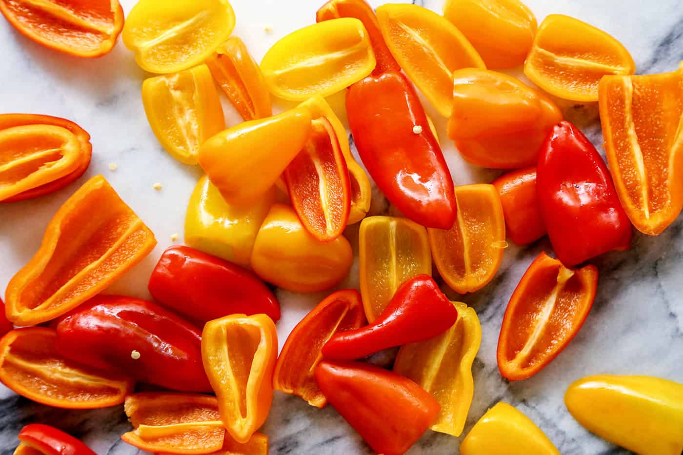 Halved mini sweet peppers in a pile