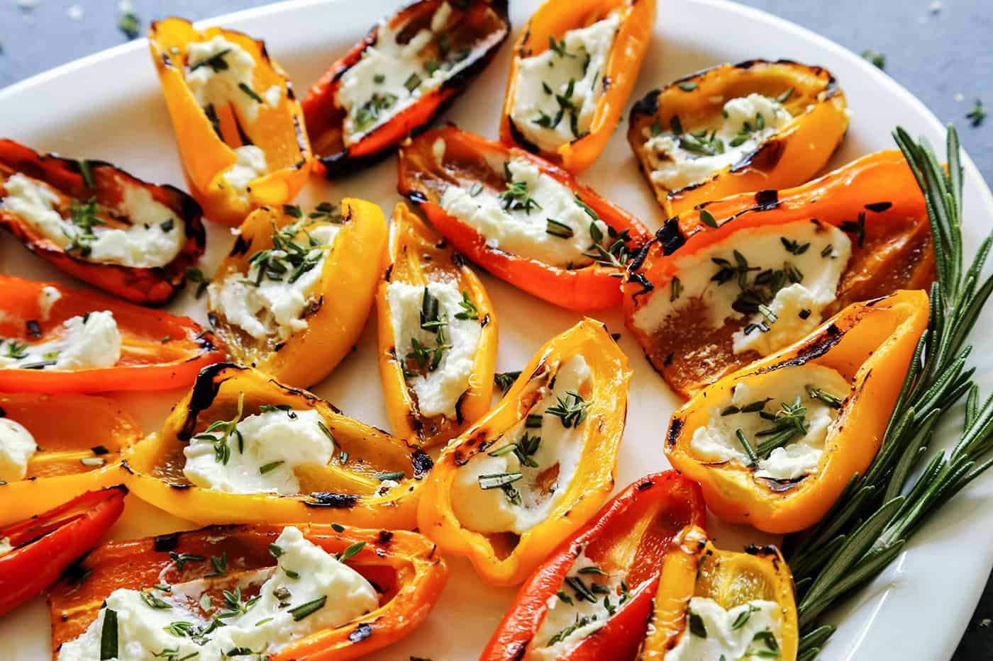 Grilled Mini Sweet Peppers filled with Goat Cheese on a white platter