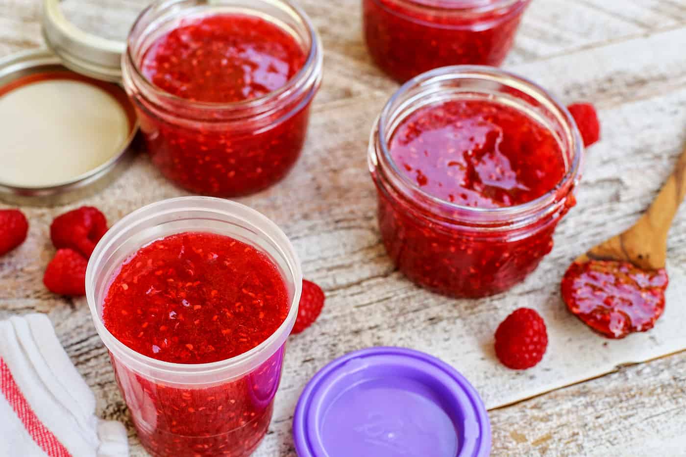 Containers filled with strawberry freezer jam