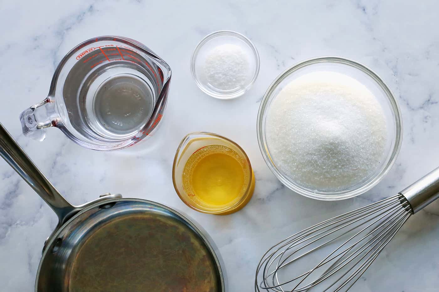 a sauce pan, whisk, white vinegar, water, sugar, and salt