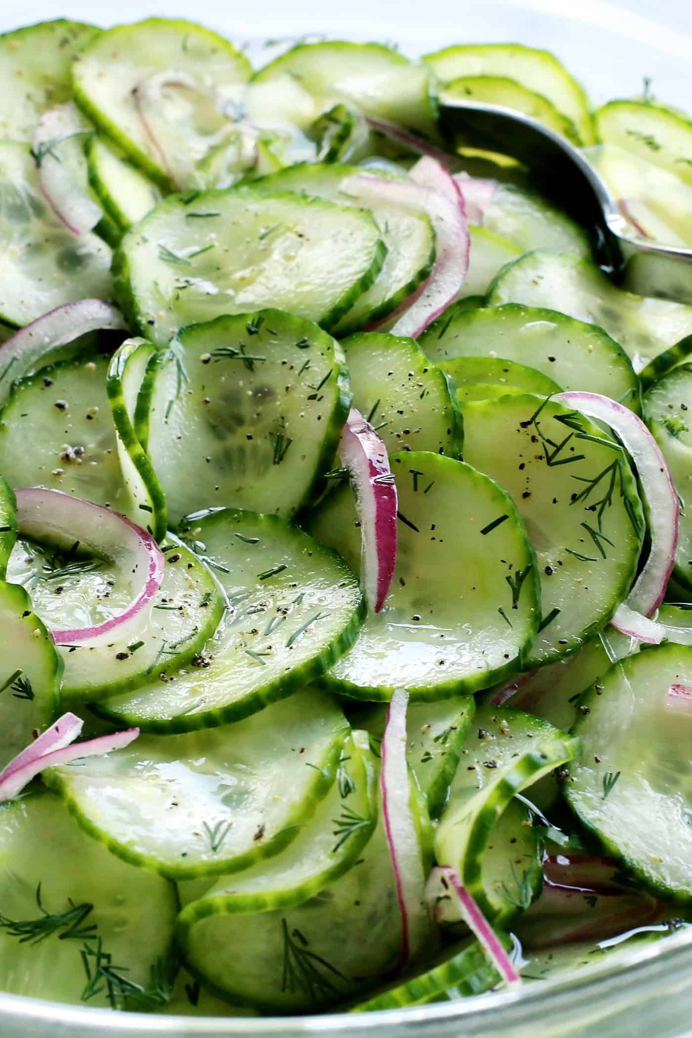 cucumber salad with vinegar in a clear bowl