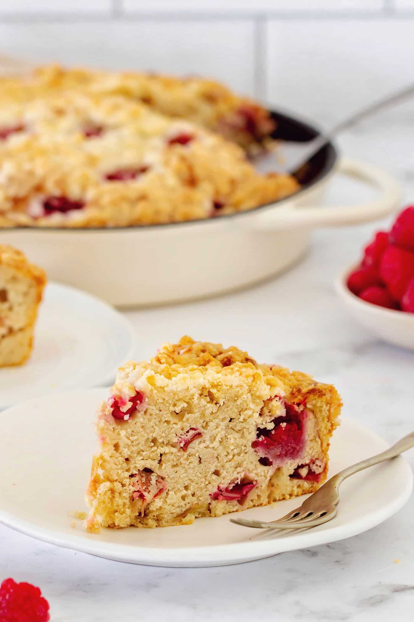 a piece of raspberry rhubarb coffee cake on a plate