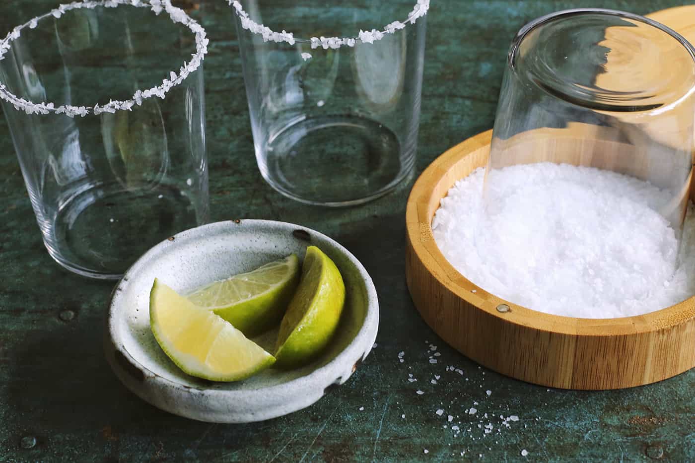 dipping rims of glasses into coarse salt