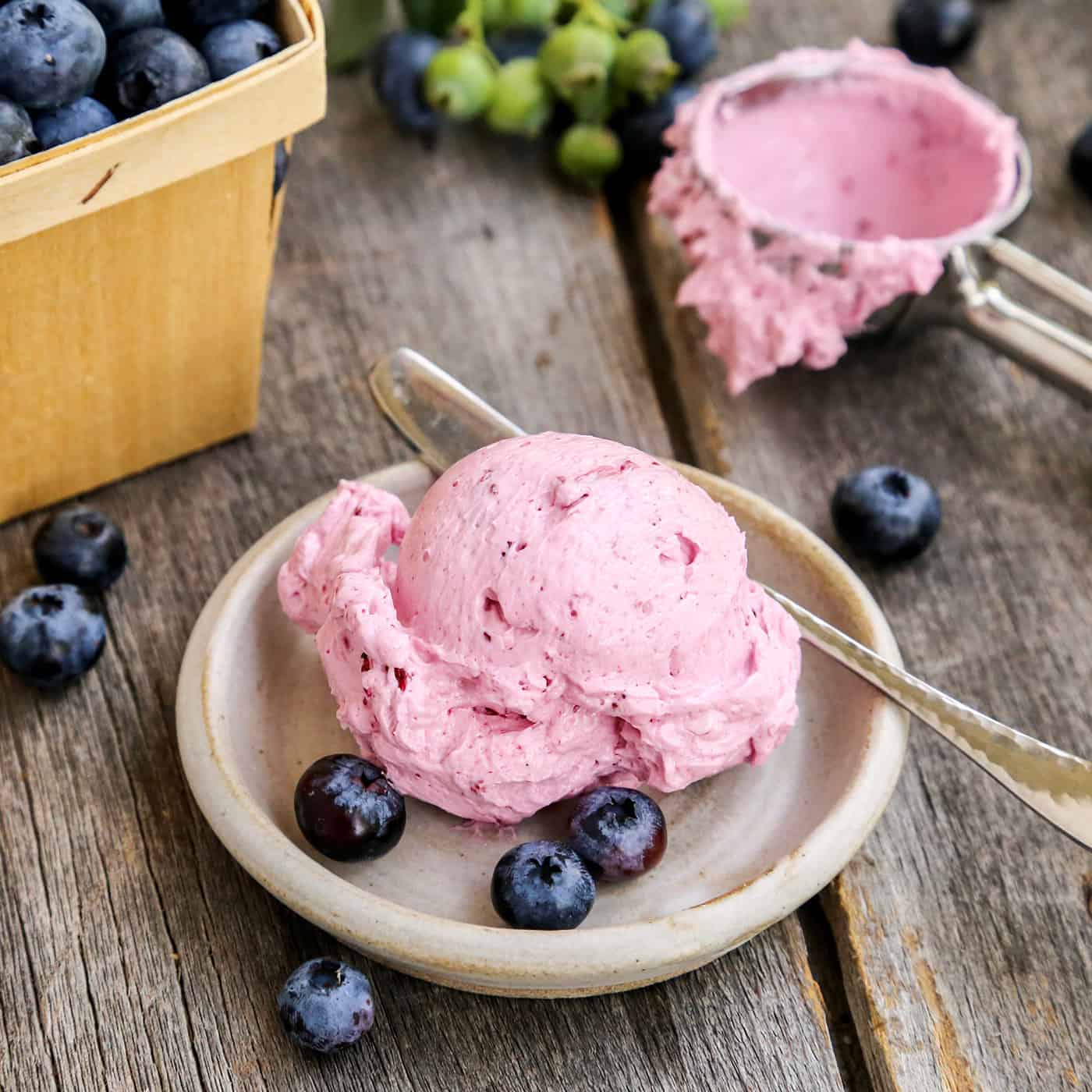 a big scoop of blueberry flavored butter on a small pottery plate