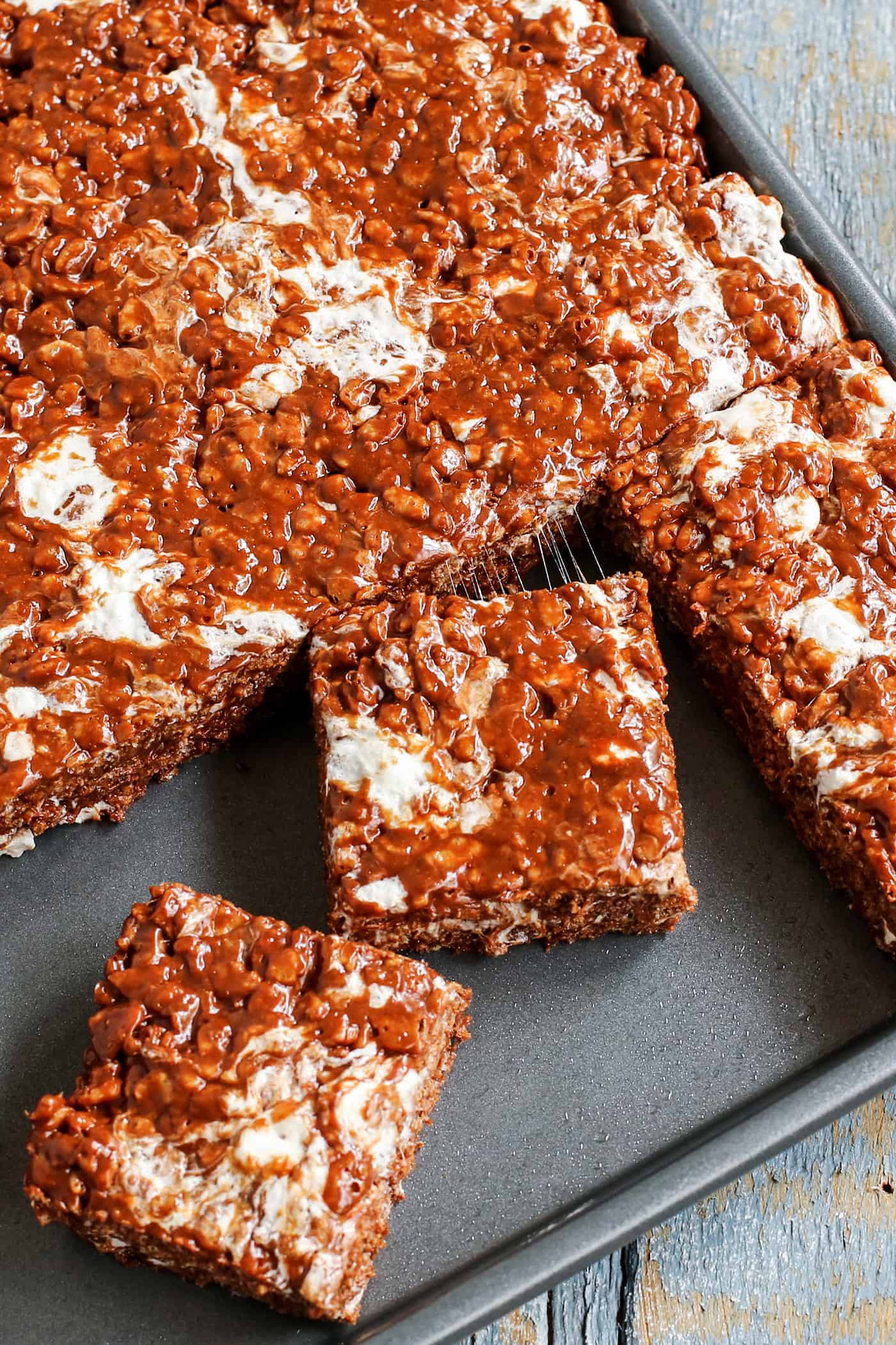 rice krispies bars with chocolate and extra marshmallow, in a baking pan