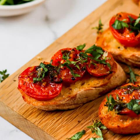 oven roasted tomato halves on slices of toasted baguette