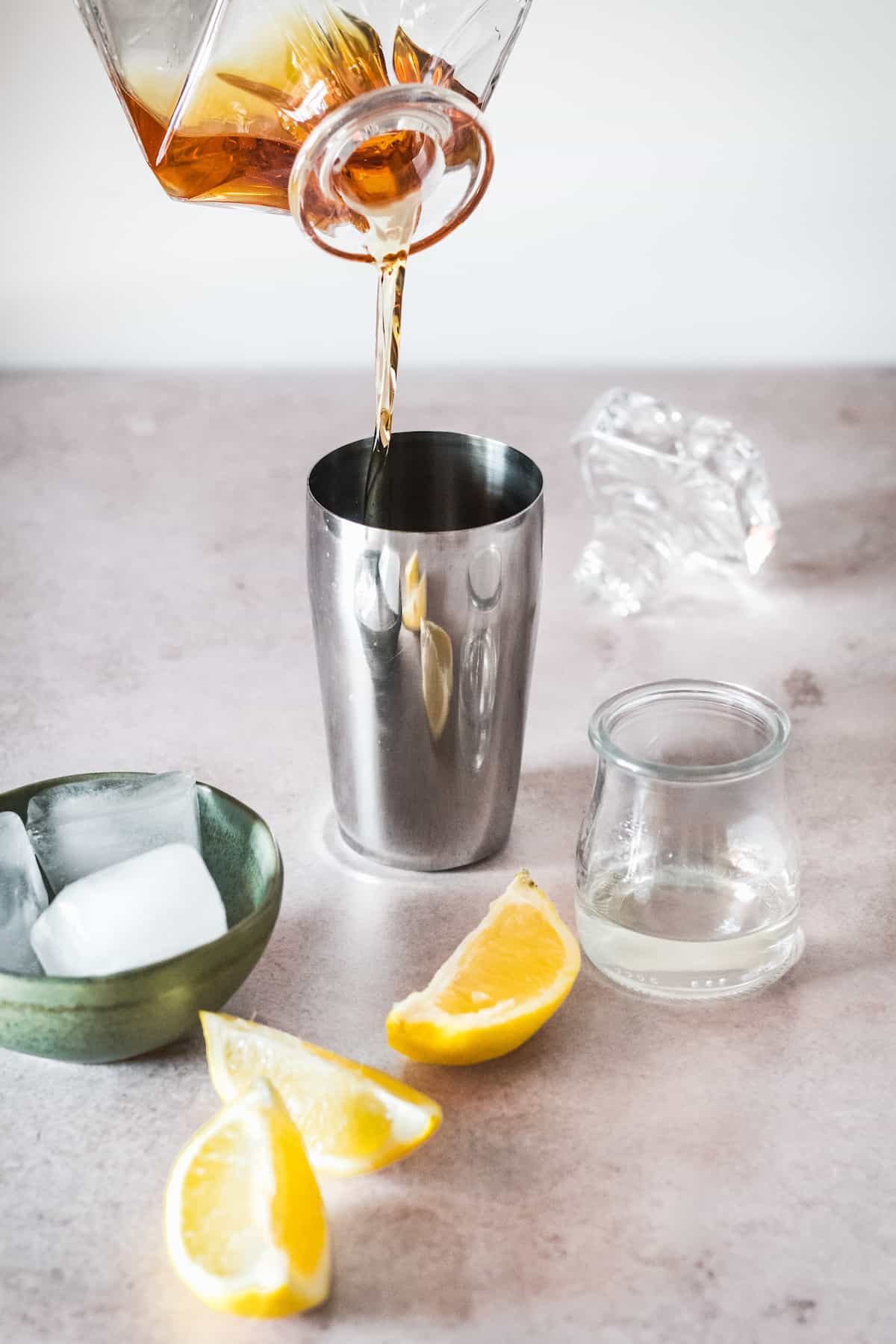 Whiskey being poured into a shaker