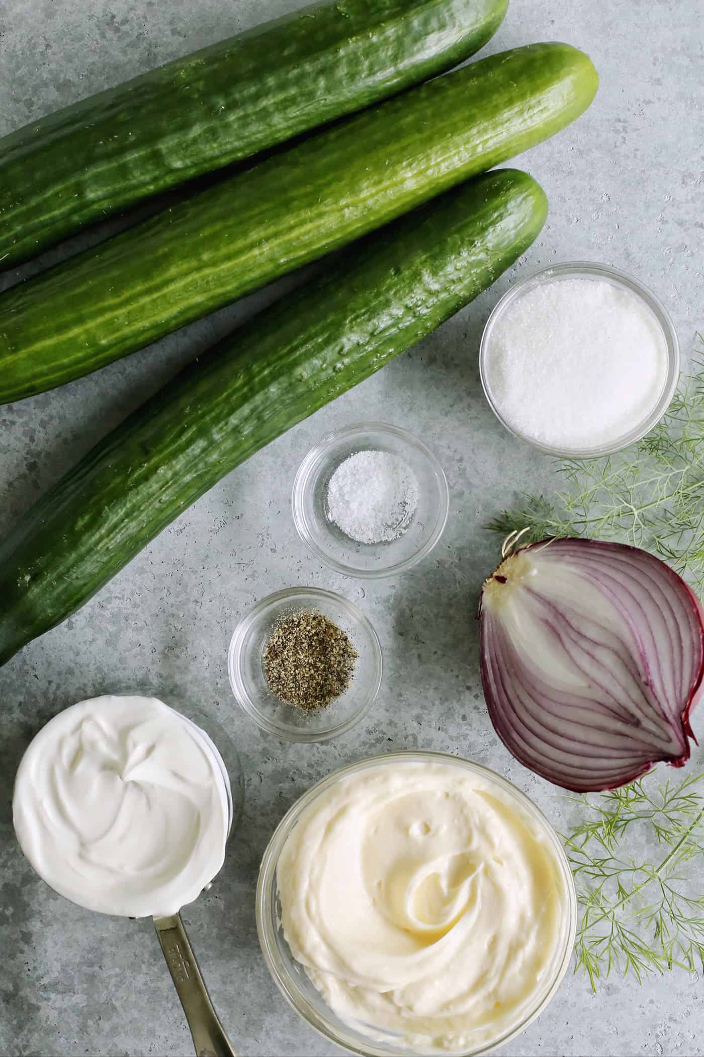 cucumbers, red onion, dill, mayonnaise, sour cream, sugar, salt, and pepper