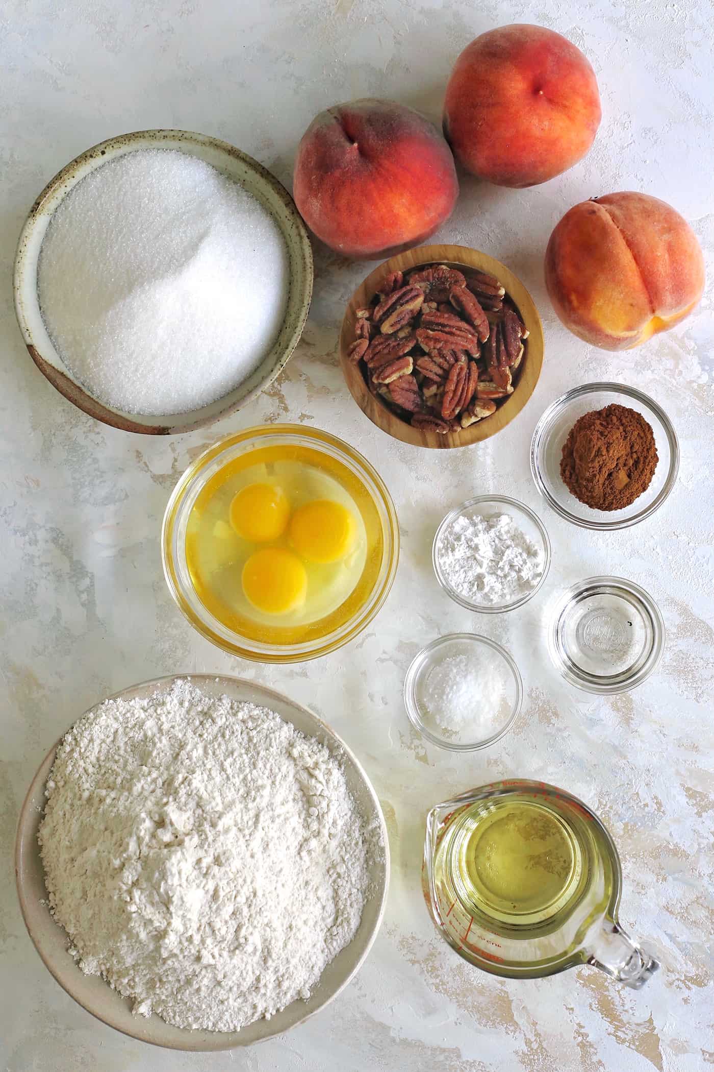 ingredients for peach bread, in separate bowls