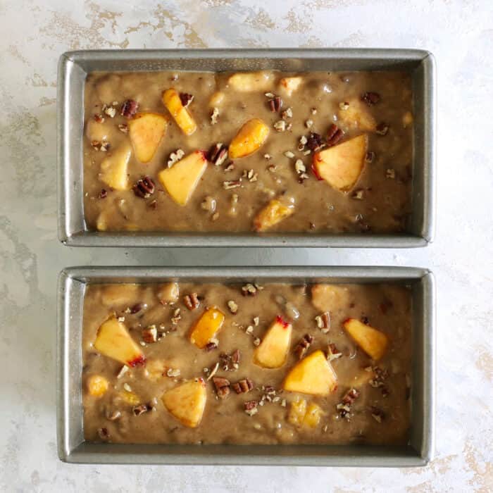 peach bread batter in two bread pans