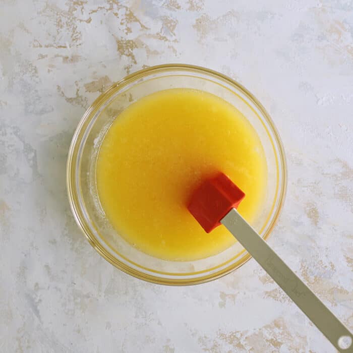 wet ingredients in a clear bowl with a spatula