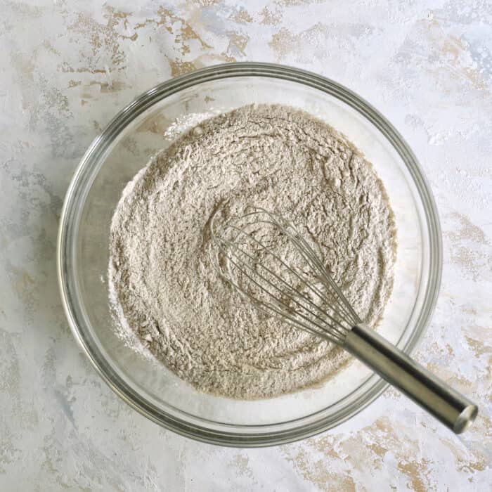 dry ingredients in a clear bowl with a whisk