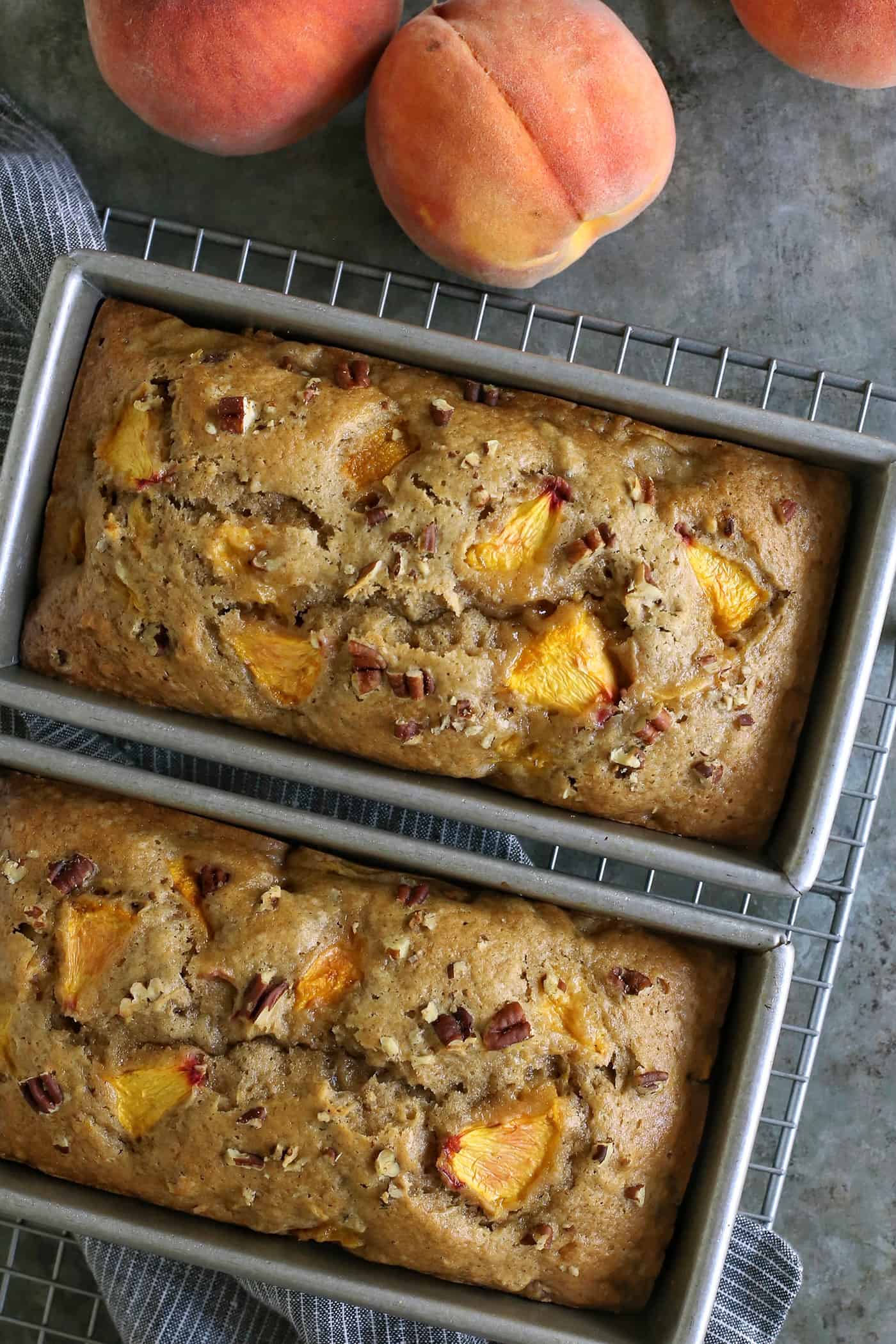 two loaves of peach bread still in the baking pans