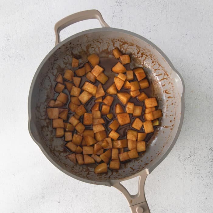 sauteeing the chopped apples in a skillet