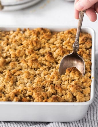 baked oatmeal with apples and a crunchy streusel topping, in a square white baking dish