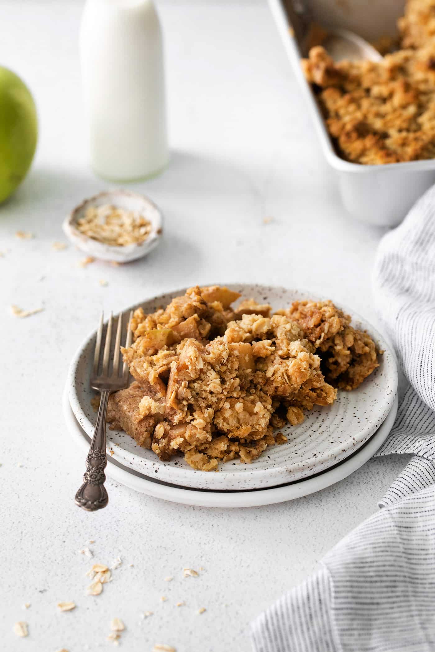 baked apple oatmeal with a crunchy topping on a small plate