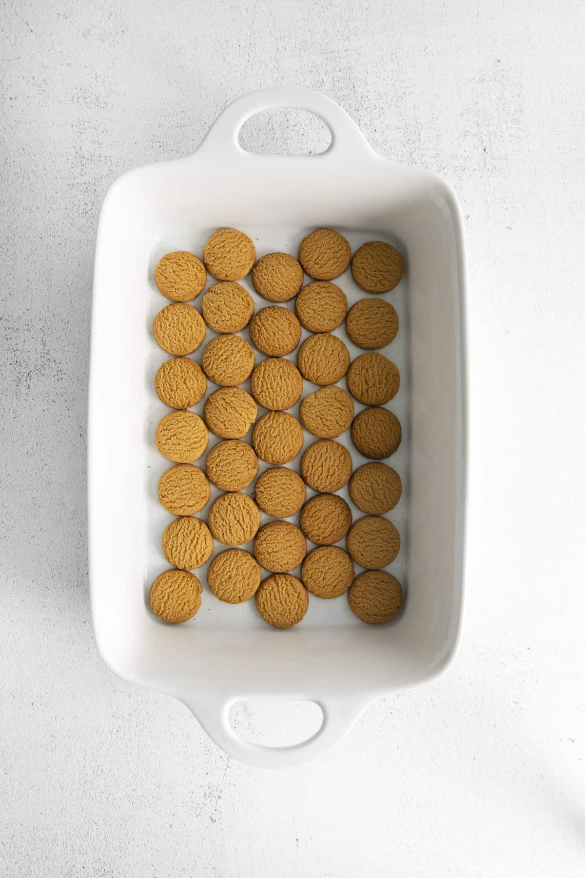 Overhead shot of ginger snaps arranged in bottom of baking dish