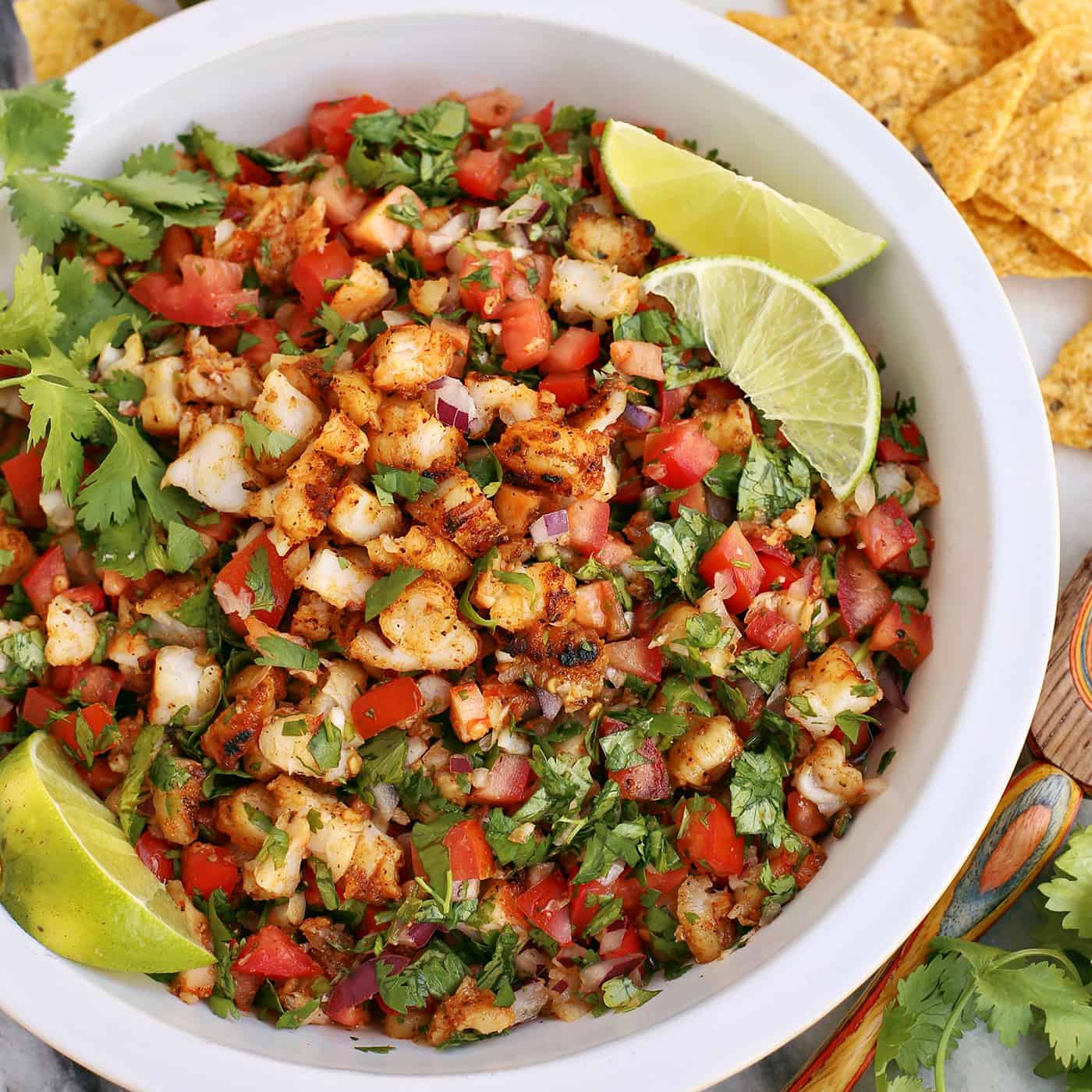 grilled shrimp ceviche in a white bowl, with tortilla chips