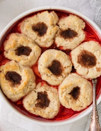 cinnamon apple puffs dessert in a round white baking dish