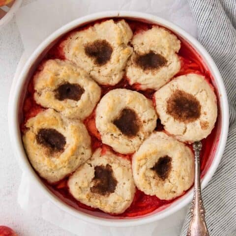 cinnamon apple puffs dessert in a round white baking dish