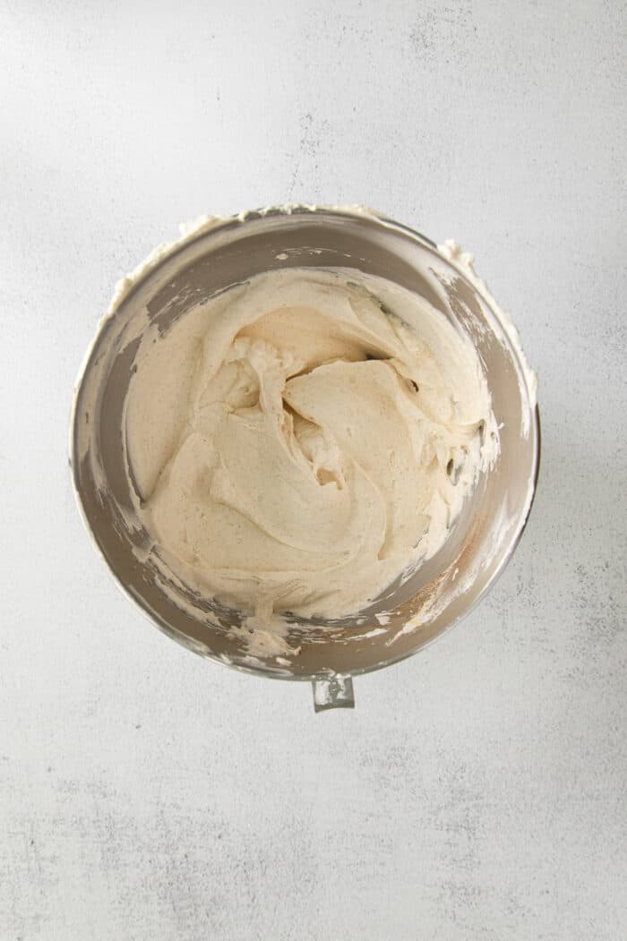 whipped cream and whipped cream cheese combined in a stainless steel mixing bowl