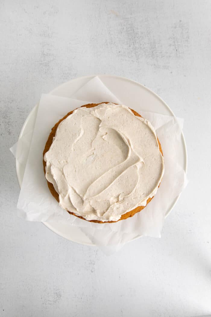 creamy cinnamon whipped topping on the bottom layer of pumpkin cake